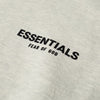 Light oatmeal fleece hoodie for kids from Fear of God Essentials, featuring soft fabric and casual style.