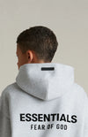 Kids Fear of God Essentials fleece hoodie in Dark Oatmeal, soft fleece fabric with hood and front pocket.