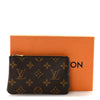Louis Vuitton Monogram leather key pouch with designer coin purse and key chain set, featuring iconic monogram pattern and compact design.