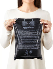 Woman holding disposable dog poop bags with dispenser and leash clip for easy pet waste cleanup.