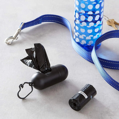 Dog poop bag dispenser with unscented leak proof bags and blue dog collar strap.