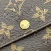 Louis Vuitton monogram canvas long wallet with flap closure, featuring gold-tone hardware and multiple card slots.