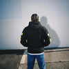 Black and yellow Sp5der Essential hoodie featuring a star design, worn by a young person, streetwear style, authentic Young Thug look.