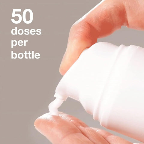 Close-up of K18 Leave in Molecular Hair mask on fingertips with text 50 doses per bottle above pic.