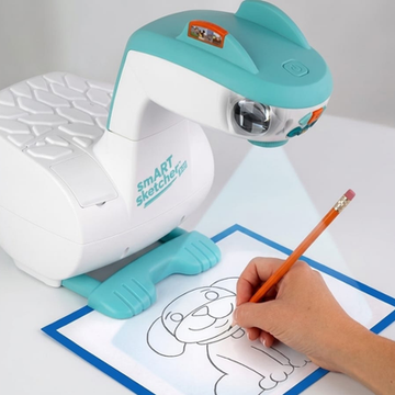 Smart Sketcher device drawing a cartoon dog on paper with a hand holding a pencil.