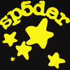 Black and yellow Sp5der Essential hoodie featuring star designs, styled for streetwear, worn by a model.