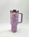 Purple Stanley tumbler with floral design on a white background