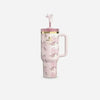 Floral-patterned mug with a pink lid on a white background