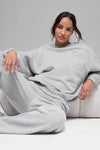 Alo Yoga unisex heather grey fleece crewneck sweatshirt with ribbed cuffs and collar, showcasing a comfortable pullover design.