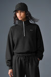 Black Alo Yoga unisex Accolade half-zip fleece sweatshirt with quarter-zip neckline and relaxed fit.