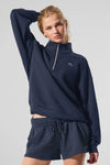 Navy blue Alo Yoga unisex Accolade half-zip sweatshirt with quarter-zip fleece pullover, front zipper and relaxed fit.