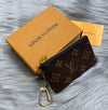 Louis Vuitton Monogram key pouch and coin purse set with leather wallet and key chain, featuring signature designer monogram pattern.