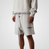 Light oatmeal Fear of God Essentials sweat shorts with a relaxed fit, featuring a comfortable waistband and casual style.