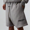 Dark oatmeal Fear of God Essentials Sweat Shorts with elastic waistband and relaxed fit, made by THE EA STORE.