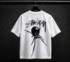 Black Widow 8-Ball graphic tee by Stüssy, off-white and natural color, casual essentials t-shirt with bold graphic design.
