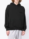 Essential Fear of God Essentials Hoodie Stretch Limo by THE EA STORE, shown in a close-up of the black hoodie fabric and design.
