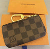 Louis Vuitton Damier Ebene leather key pouch with coin and key purse set, featuring signature checkerboard pattern and compact design.