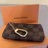 Louis Vuitton Damier Ebene key pouch and coin purse set featuring leather construction and designer pattern.