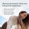 Woman with long hair outdoors holding Nutrafol Women's Hair Growth Vitamins dietary supplement for thicker, fuller, stronger hair.