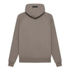 Fear of God Essentials hoodie in desert taupe, featuring a soft fabric and relaxed fit, styled on a model.