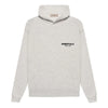 Light oatmeal Fear of God Essentials hoodie from THE EA STORE, featuring a cozy, casual fit and soft fabric.