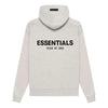 Light oatmeal Fear of God Essentials hoodie from THE EA STORE, featuring a cozy, casual fit with a branded logo on the front.