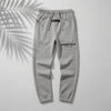 Dark oatmeal Fear of God Essentials relaxed sweatpants from THE EA STORE with a soft, comfortable fit and elastic waistband.