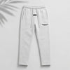 Light oatmeal Fear of God Essentials relaxed sweatpants from THE EA STORE, showing the comfortable fit and soft fabric.