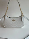 Coach Teri 2-Way Shoulder Bag in Signature coated canvas, white with silver-tone hardware and adjustable strap.