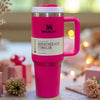 Dark pink Stanley 40 oz Quencher H2.0 FlowState insulated stainless steel tumbler with handle, lid, and straw for travel and hydration.