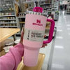 Stanley 40 oz Quencher H2.0 insulated tumbler with handle, leak-resistant lid, soft pink and fuchsia design, fits car cup holders.