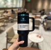 Person holding a Stanley 40 oz Quencher H2.0 Tumbler in black iridescent chrome, vacuum insulated and spill-resistant.
