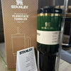 Stanley Wicked x Target Elphaba 40oz H2.0 Flowstate Quencher Tumbler with packaging and user manual on reflective surface.