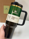 Green Stanley Wicked x Target 40oz Elphaba H2.0 FlowState water bottle held in hand against neutral background