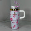 Stanley x Love Shack Fancy 40oz Ribbon Rosa FlowState H2.0 stainless steel tumbler with floral pattern and Stanley logo on neutral background