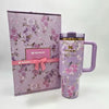 Stanley x LoveShackFancy "Happy Thoughts" 40oz Rosa Beaux Purple water bottle with floral design and insulated stainless steel body.