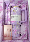 Stanley x LoveShackFancy Rosa Beaux Purple 40oz floral water bottle in decorative box with a card inside.
